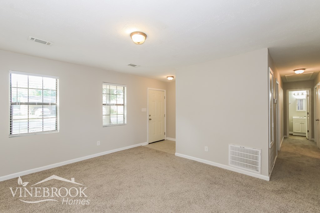 the living room and hallway of an empty house